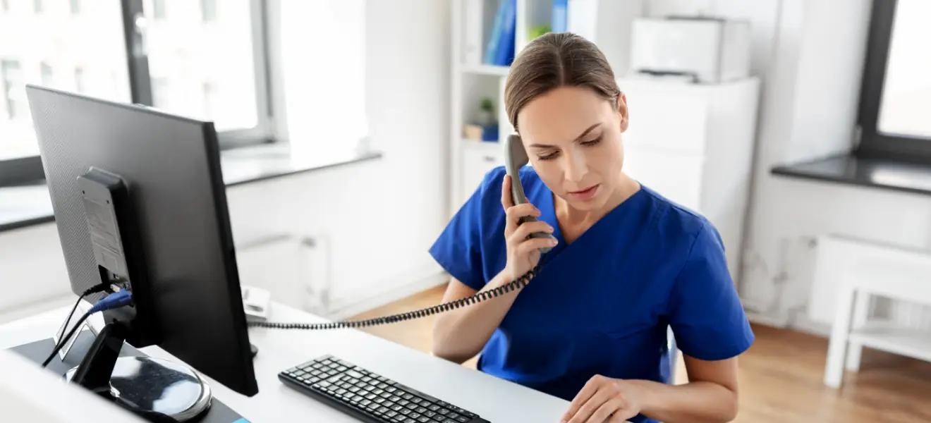 medicine, technology and healthcare concept - female doctor or nurse with computer and clipboard calling on phone at hospital 